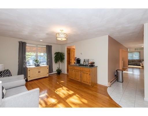 4 Rivers Lane Stoneham, MA 02180 - Photo 16 of 42 a large living room with furniture and a large window