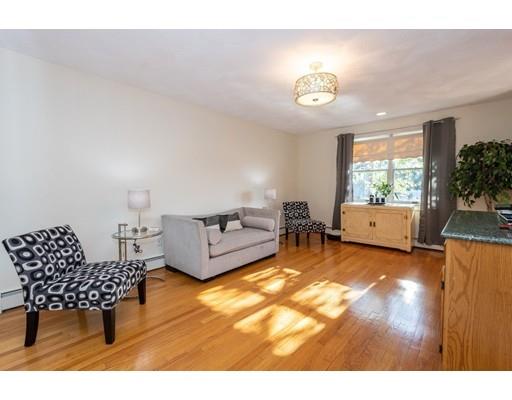 4 Rivers Lane Stoneham, MA 02180 - Photo 17 of 42 a living room with furniture and a table