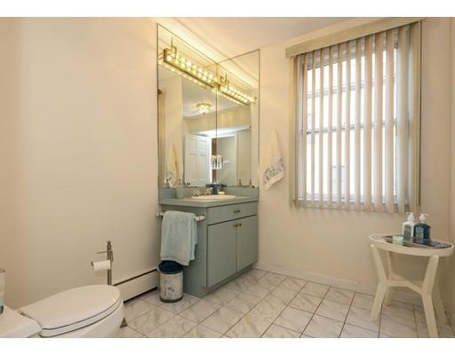 4 Rivers Lane Stoneham, MA 02180 - Photo 18 of 42 a bathroom with a sink a toilet and mirror