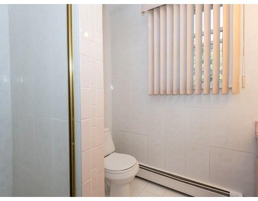 4 Rivers Lane Stoneham, MA 02180 - Photo 28 of 42 a toilet sitting in a bathroom next to a window