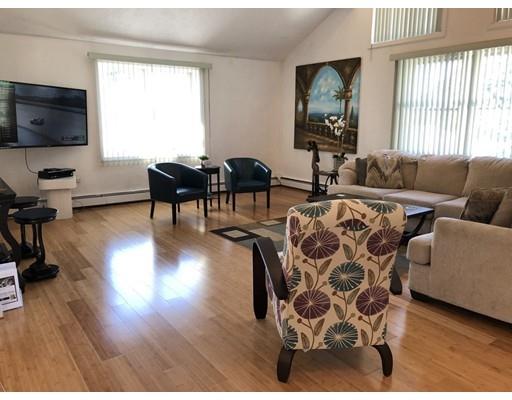 4 Rivers Lane Stoneham, MA 02180 - Photo 10 of 42 a living room with furniture fireplace and a flat screen tv