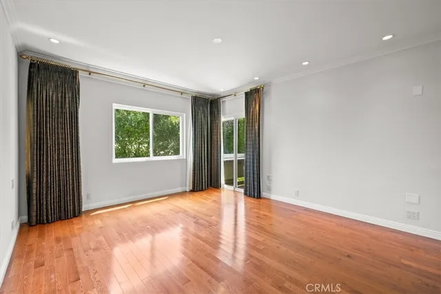 a view of an empty room with glass door