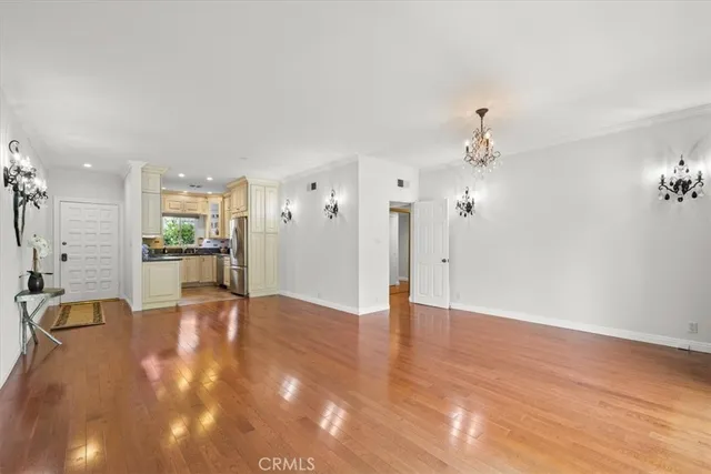 a view of an empty room and kitchen view