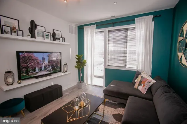 a room with stainless steel appliances table and chairs