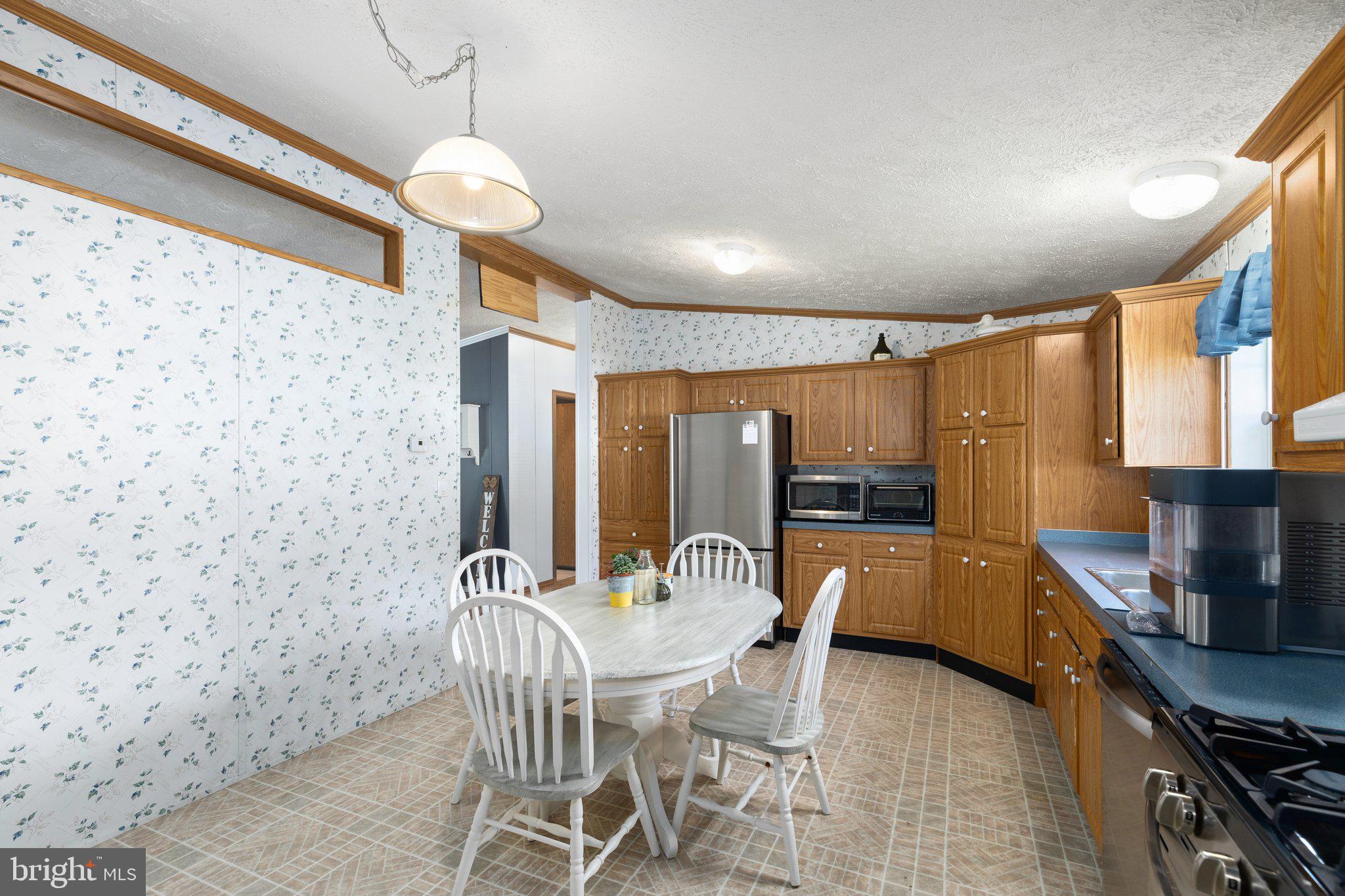 4041 Conowingo Road, Unit 29A Darlington, MD 21034 - Photo 9 of 21 a kitchen with stainless steel appliances granite countertop a sink a stove a refrigerator cabinets and chairs