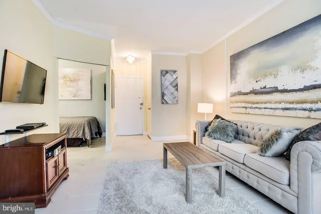 a living room with furniture and a flat screen tv