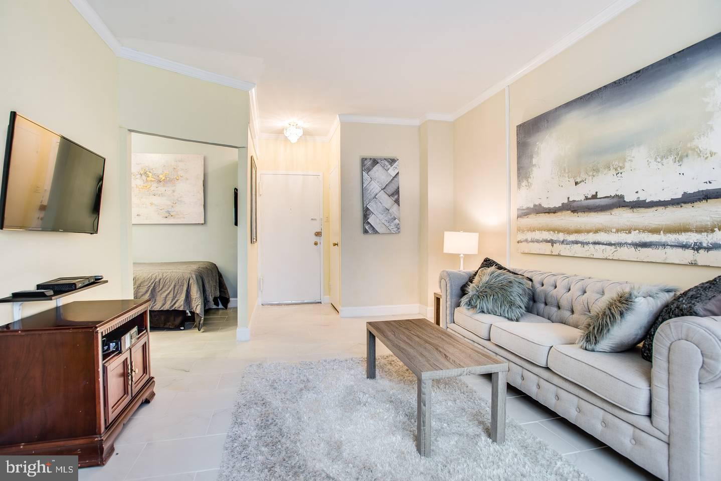 1021 Arlington Boulevard, Unit 238 Arlington, VA 22209 - Photo 3 of 20 a living room with furniture and a flat screen tv