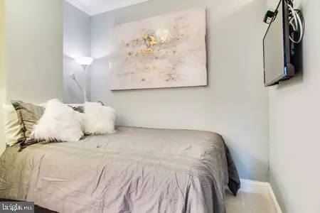 a bed with white sheets and pillows on it