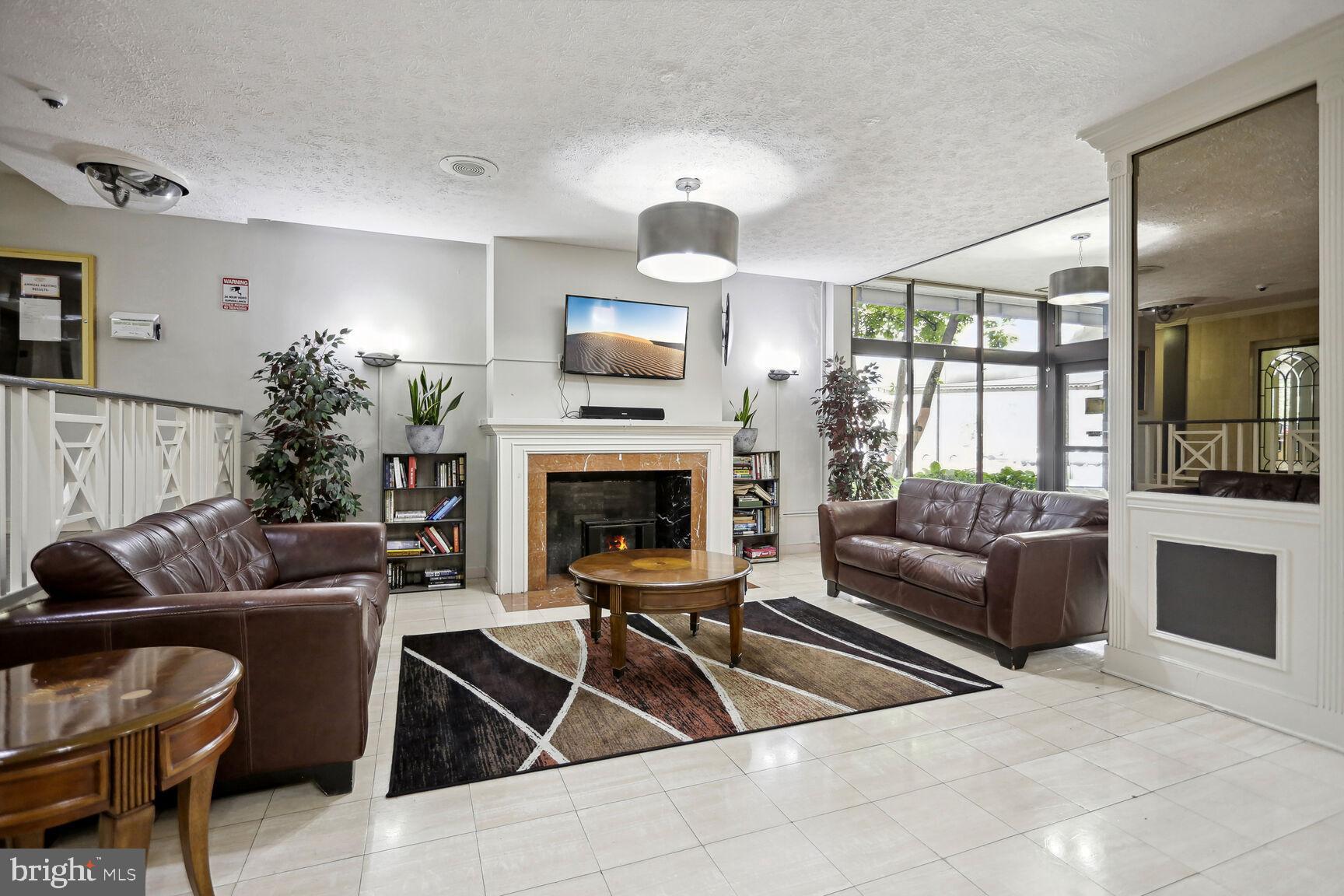 1021 Arlington Boulevard, Unit 238 Arlington, VA 22209 - Photo 7 of 20 a living room with furniture and a fireplace