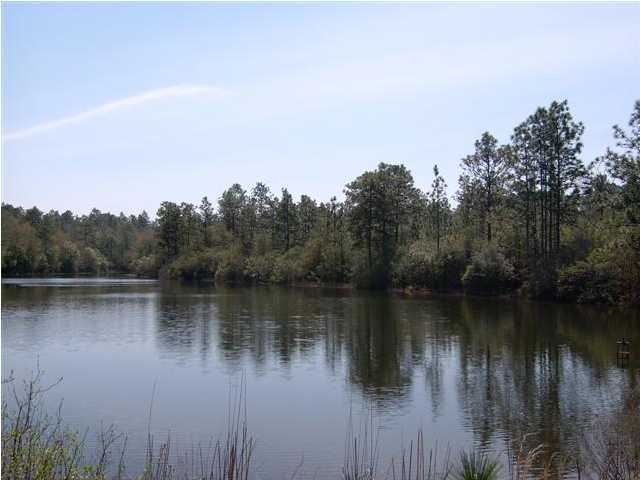 E-5 Thrush Place Crestview, FL 32539 - Photo 2 of 3 a body of water with a tree in the background