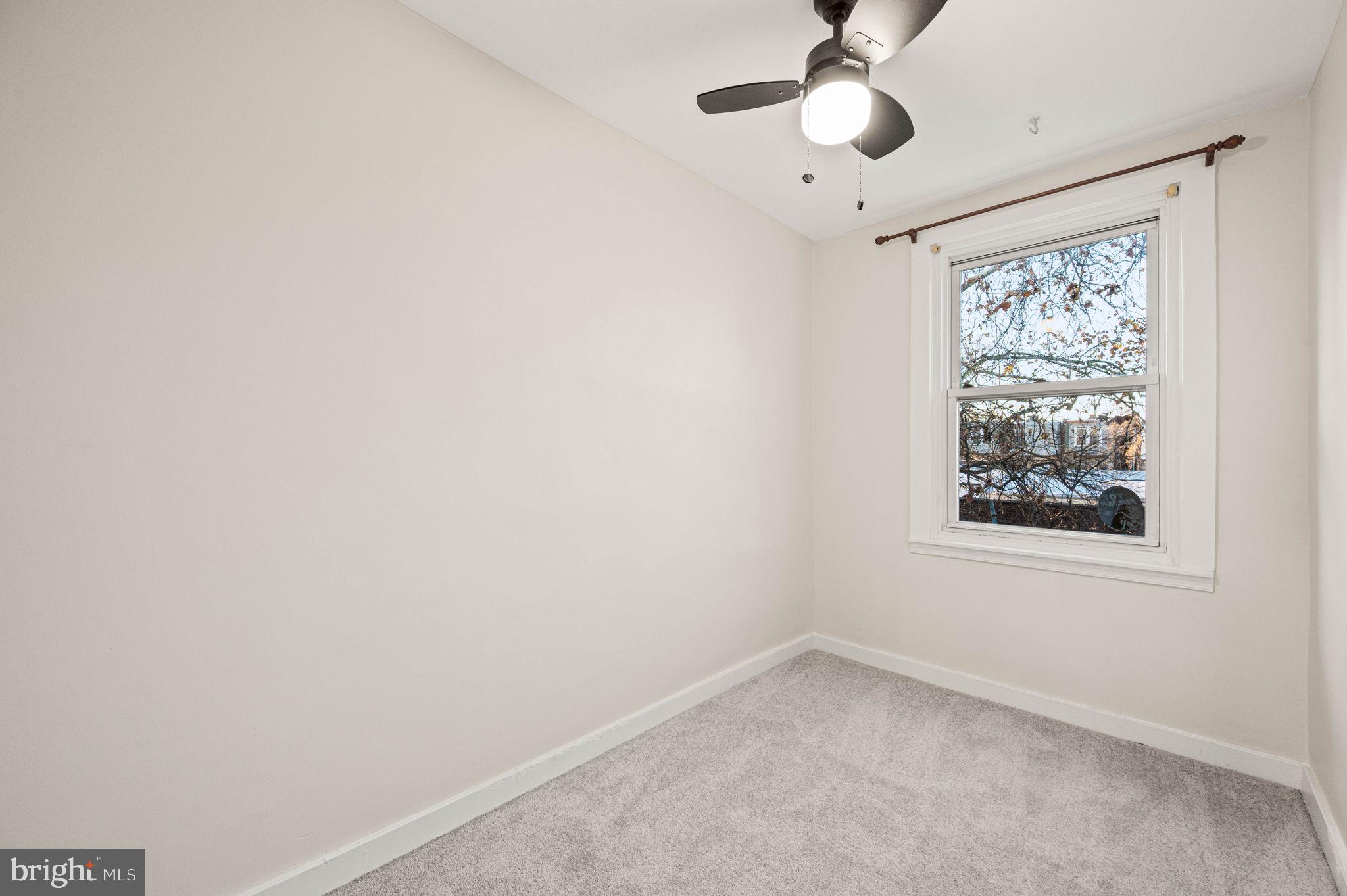 7113 Theodore Street Philadelphia, PA 19142 - Photo 17 of 26 an empty room with a window and a fan