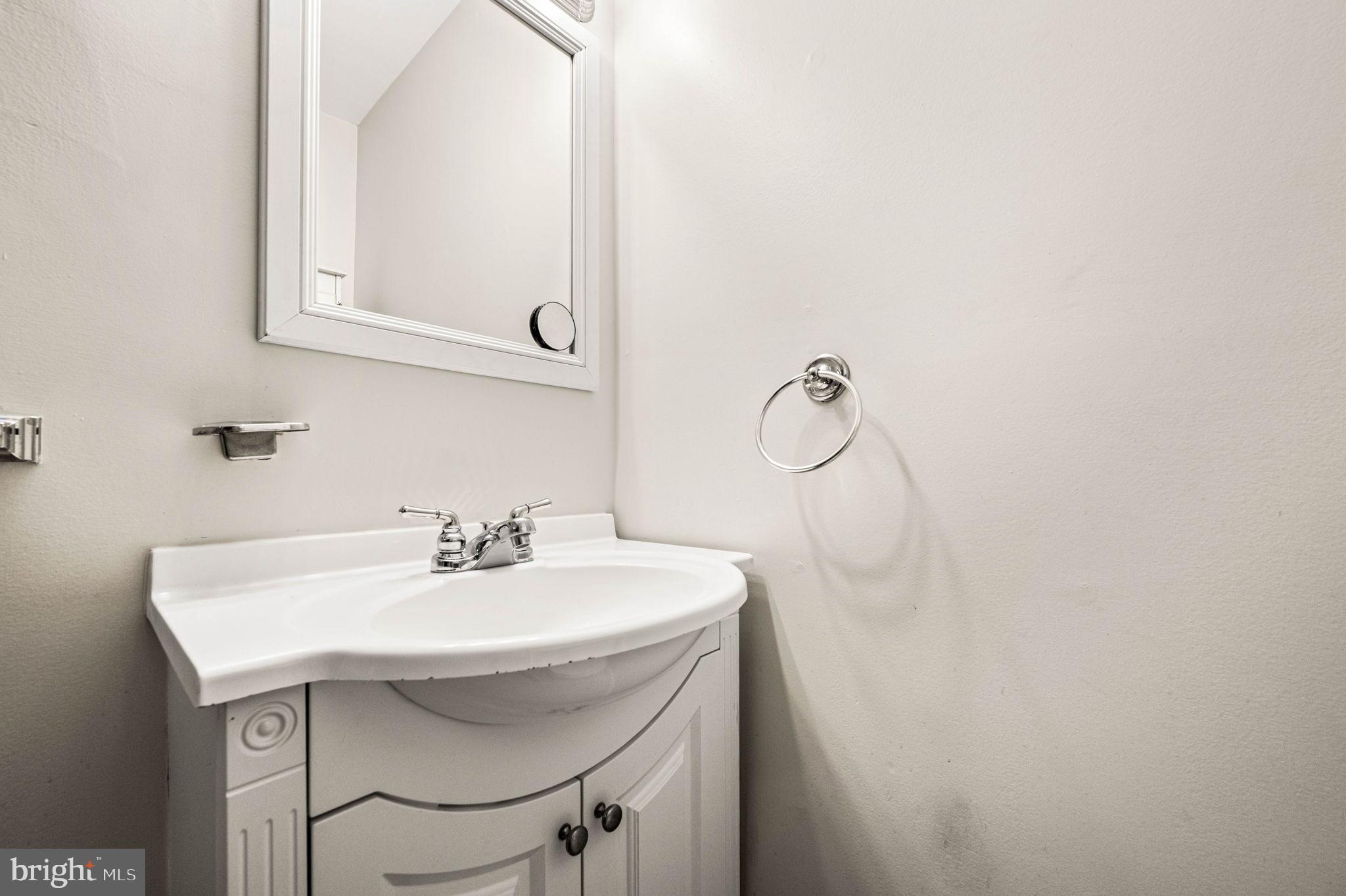 7113 Theodore Street Philadelphia, PA 19142 - Photo 18 of 26 a bathroom with a sink and a mirror