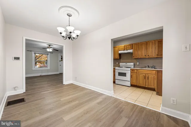 a view of kitchen with a sink cabinets and wooden floor