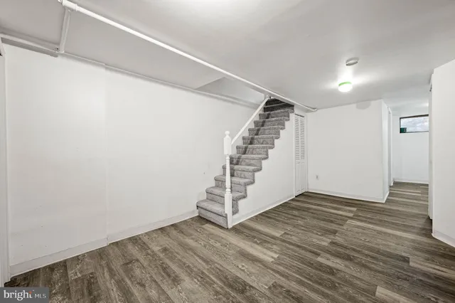 a view of a room with wooden floor and white walls