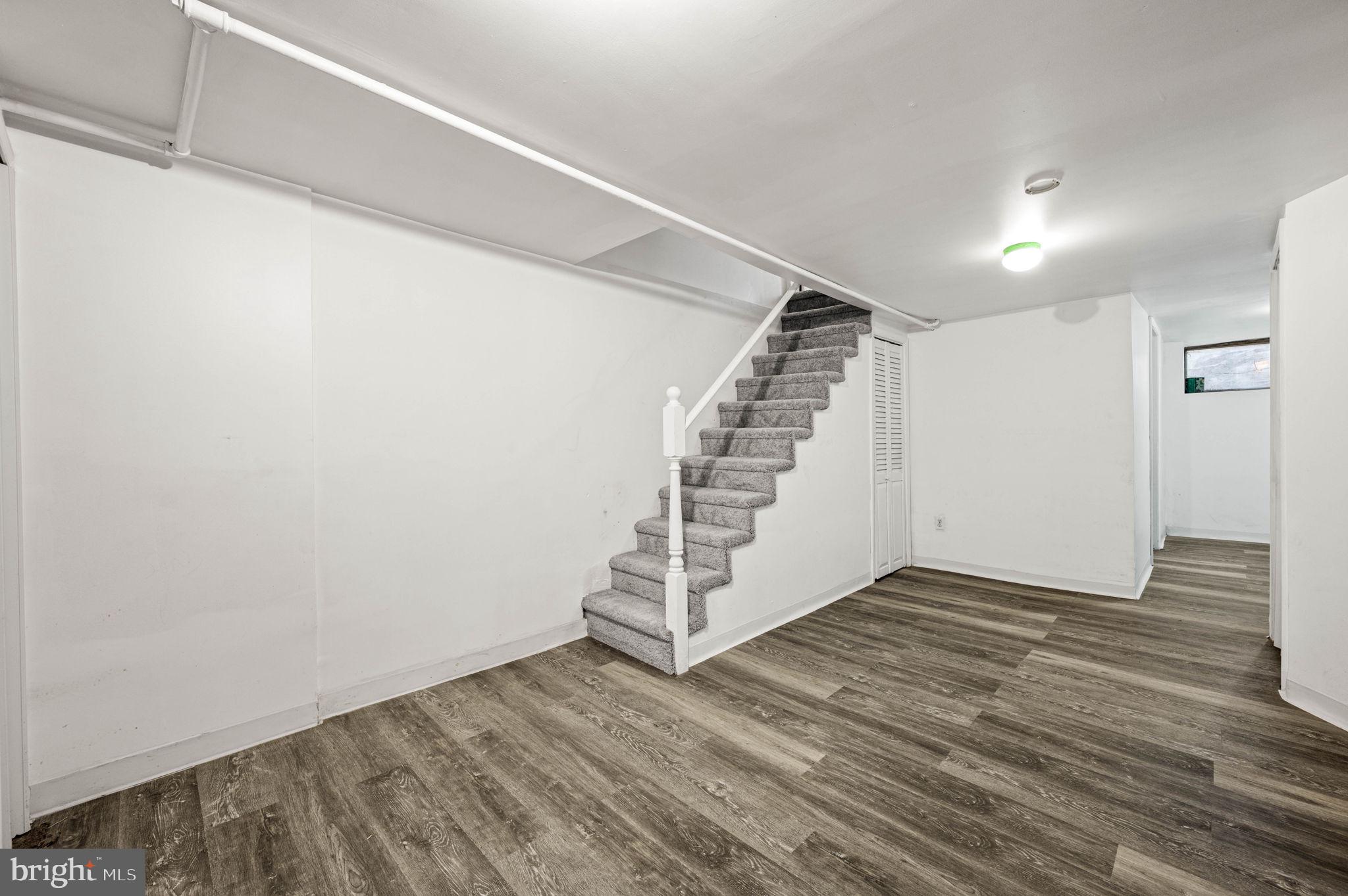 7113 Theodore Street Philadelphia, PA 19142 - Photo 3 of 26 a view of a room with wooden floor and white walls