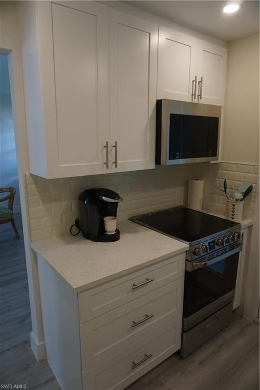 663 12th Avenue South, Unit 663 Naples, FL 34102 - Photo 11 of 14 a kitchen with a stove and a microwave