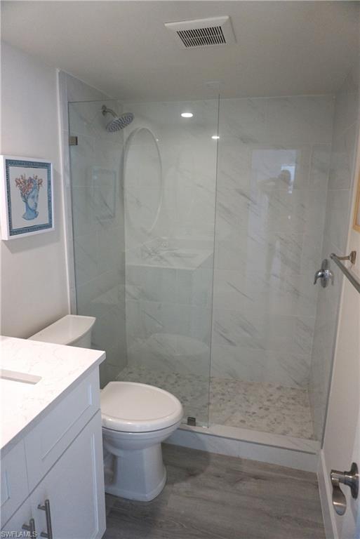 663 12th Avenue South, Unit 663 Naples, FL 34102 - Photo 12 of 14 a bathroom with a toilet a sink and shower