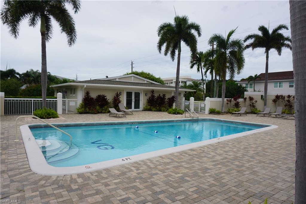 663 12th Avenue South, Unit 663 Naples, FL 34102 - Photo 3 of 14 a view of a swimming pool with a garden