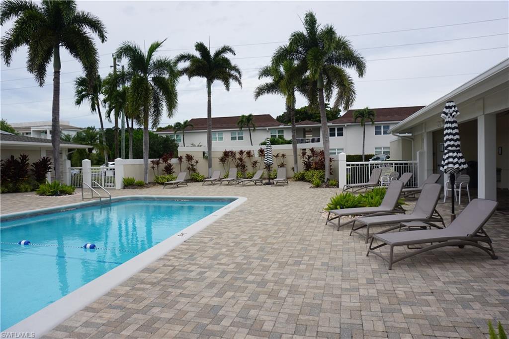 663 12th Avenue South, Unit 663 Naples, FL 34102 - Photo 4 of 14 a swimming pool with outdoor seating