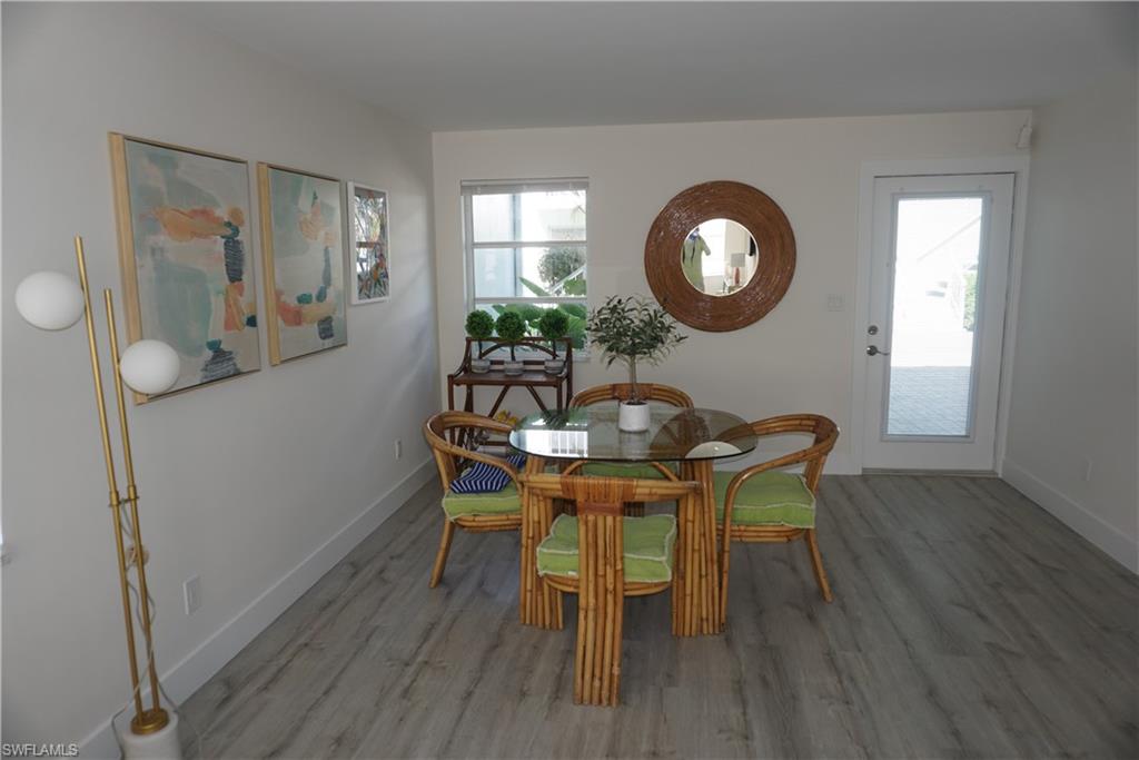 663 12th Avenue South, Unit 663 Naples, FL 34102 - Photo 8 of 14 a view of a dining room with furniture and wooden floor