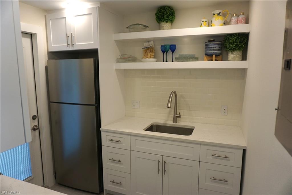 663 12th Avenue South, Unit 663 Naples, FL 34102 - Photo 9 of 14 a kitchen with appliances and cabinets