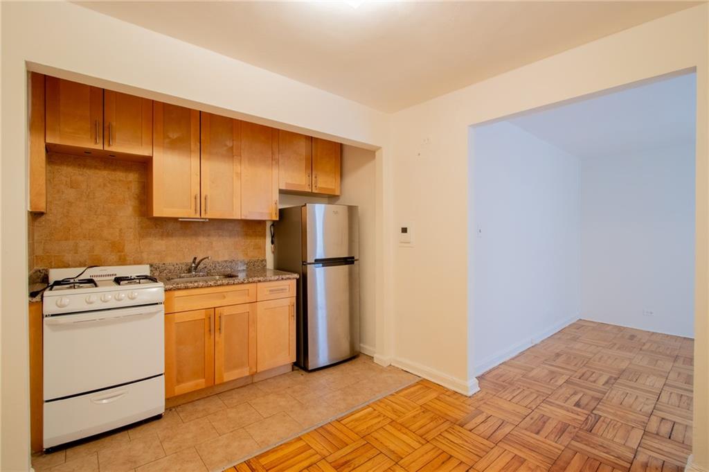 35 Oliver Street, Unit 1D Brooklyn, NY 11209 - Photo 2 of 23 a kitchen with white cabinets and white appliances