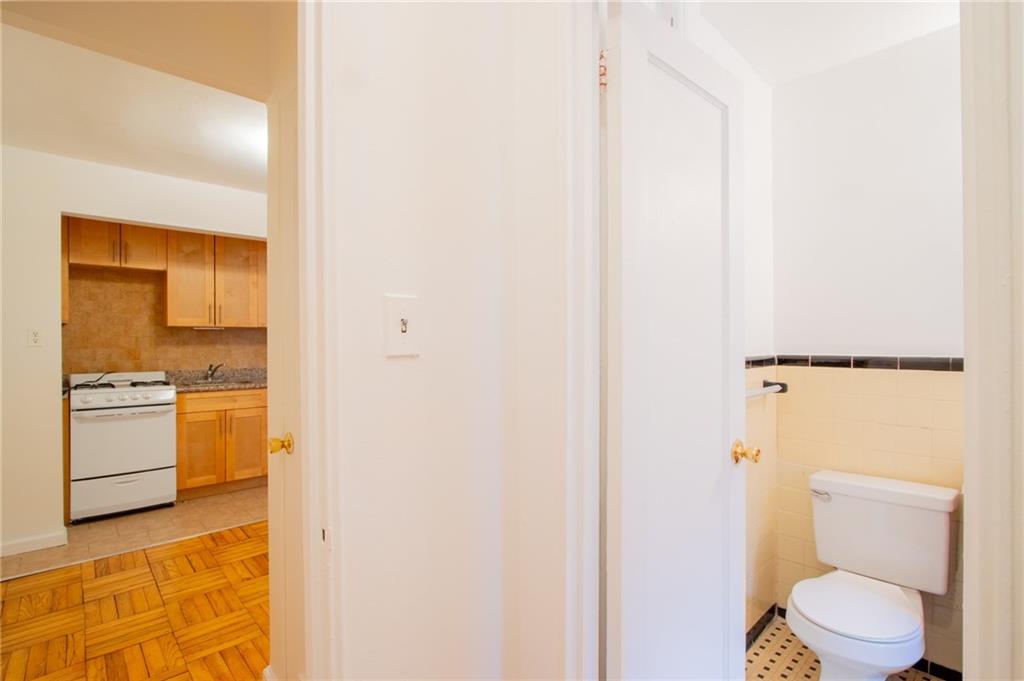 35 Oliver Street, Unit 1D Brooklyn, NY 11209 - Photo 9 of 23 a bathroom with a toilet sink and a mirror
