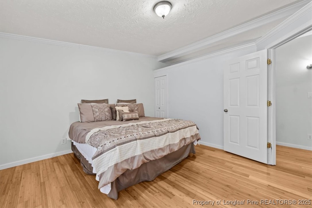 11891 Aberdeen Road Aberdeen, NC 28315 - Photo 12 of 35 a spacious bedroom with a bed and wooden floor