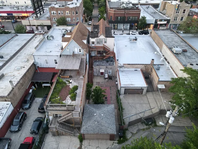 an aerial view of multiple houses with outdoor space