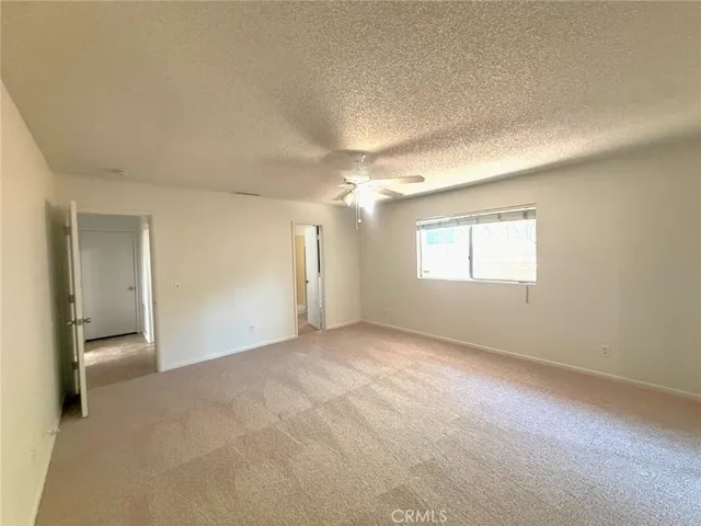 a spacious bathroom with a granite countertop sink mirror and a toilet