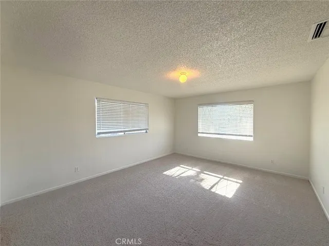 a bathroom with a granite countertop sink a large mirror and a shower