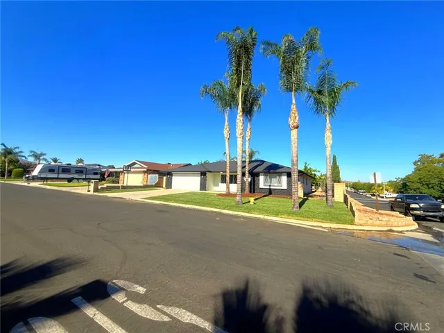 a view of a house with a yard and street view