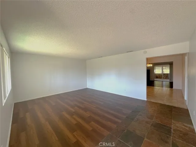 a large kitchen with kitchen island a sink dishwasher a stove and a refrigerator with wooden floor