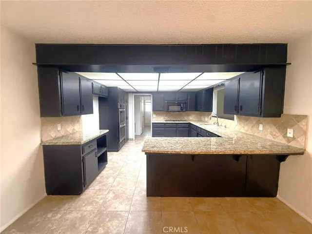 a kitchen with a sink and wooden cabinets