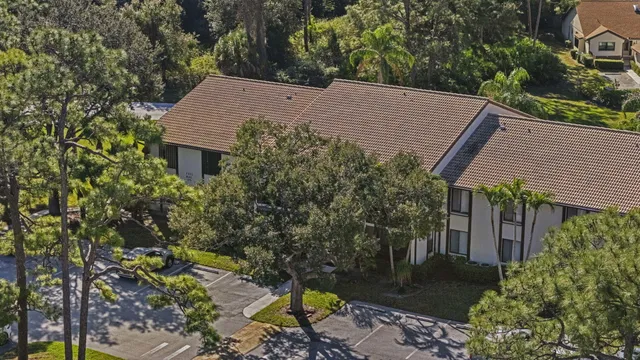 an aerial view of residential houses with outdoor space and a lake view