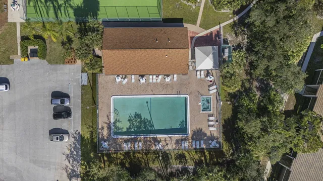 a green field with some trees in front of it