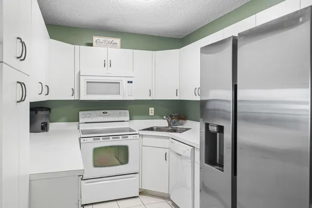 a utility room with cabinets washer and dryer
