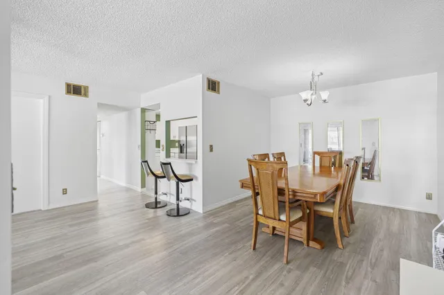 a dining room with furniture and wooden floor