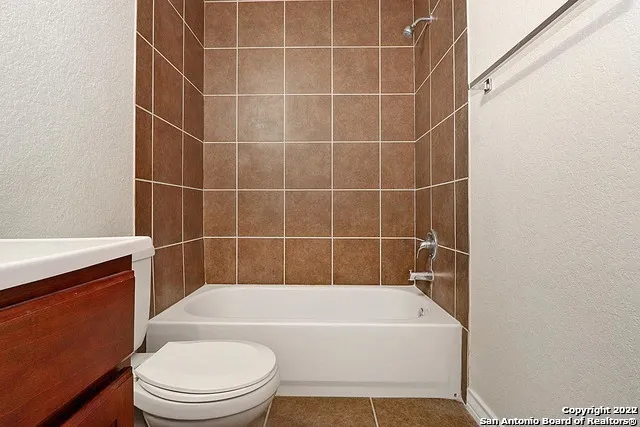 a white bath tub sitting next to a white toilet