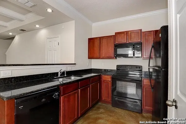 a kitchen with a sink stove and refrigerator