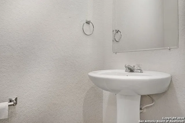 a bathroom with a sink a mirror and vanity