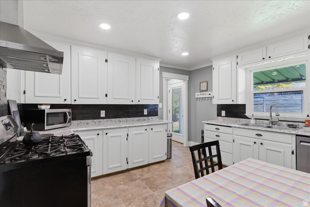 170 North 200 West Springville, UT 84663 - Photo 4 of 13 Kitchen featuring white cabinetry, light-toned countertops, a stainless steel range hood, recessed lighting, and tile flooring