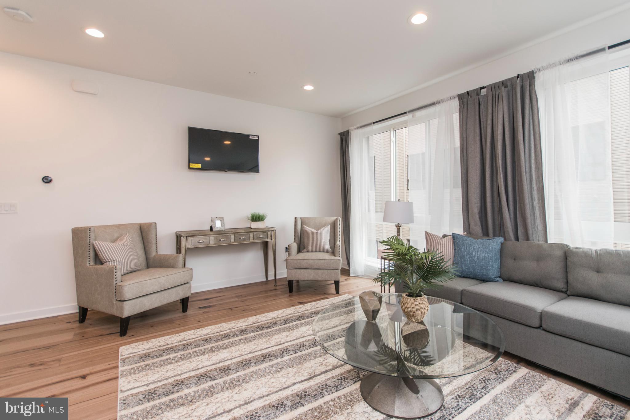 4443 River Ridge Court, Unit 13 Philadelphia, PA 19129 - Photo 11 of 35 a living room with furniture and a flat screen tv