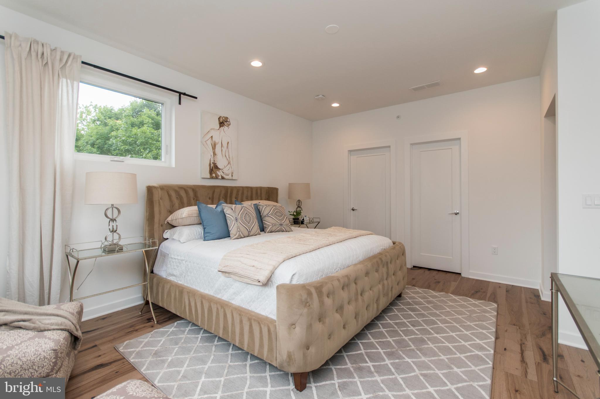 4443 River Ridge Court, Unit 13 Philadelphia, PA 19129 - Photo 21 of 35 a bedroom with a large bed and a window