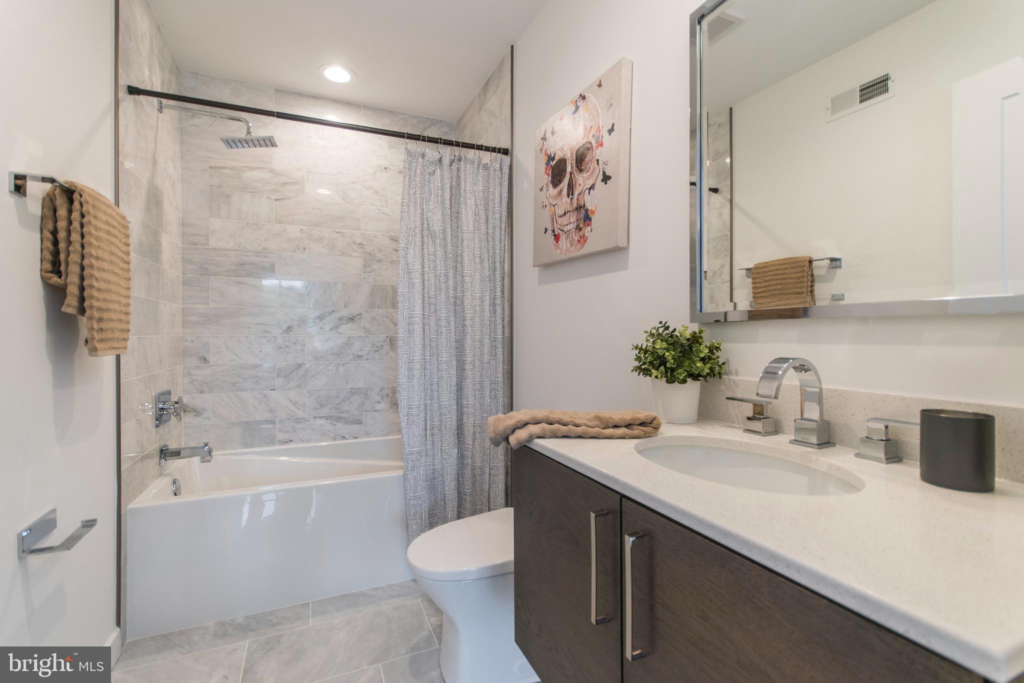 4443 River Ridge Court, Unit 13 Philadelphia, PA 19129 - Photo 24 of 35 a bathroom with a granite countertop sink a toilet and shower