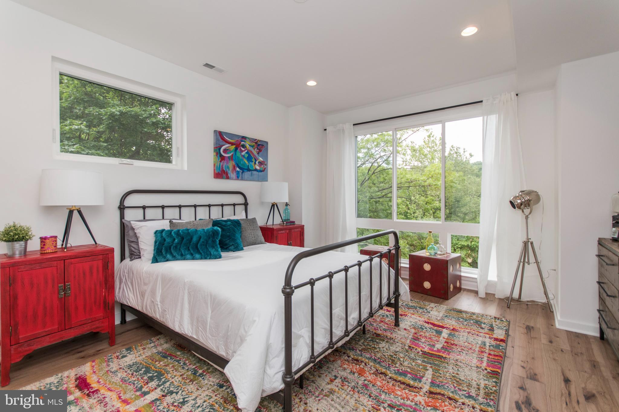 4443 River Ridge Court, Unit 13 Philadelphia, PA 19129 - Photo 26 of 35 a bed sitting in a bedroom next to a window