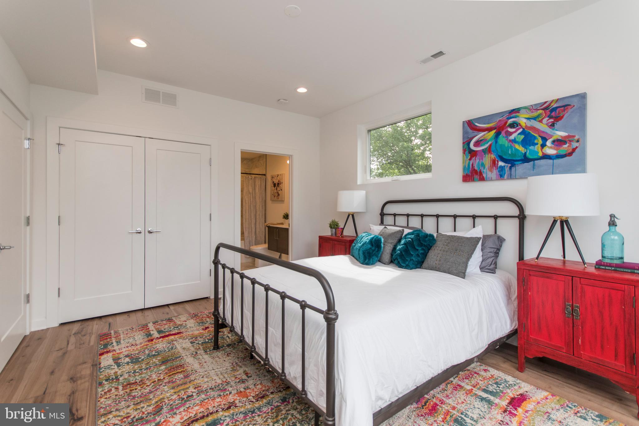 4443 River Ridge Court, Unit 13 Philadelphia, PA 19129 - Photo 27 of 35 a bedroom with a bed and a painting on the wall