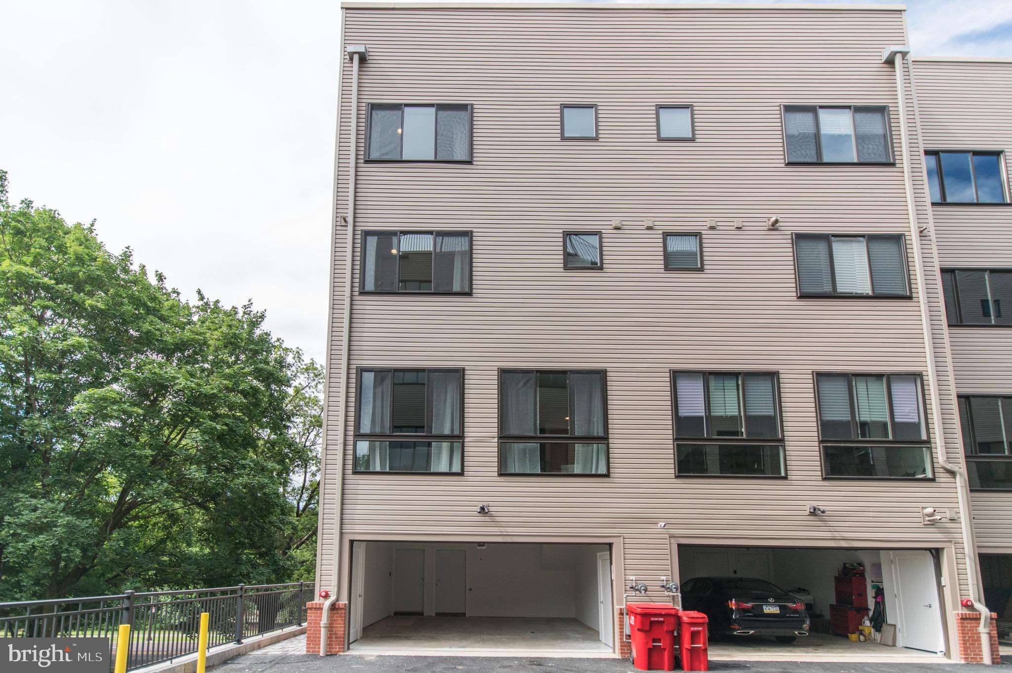 4443 River Ridge Court, Unit 13 Philadelphia, PA 19129 - Photo 34 of 35 a view of a white house with large windows
