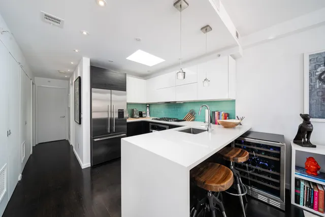 a kitchen that has a table chairs and a refrigerator