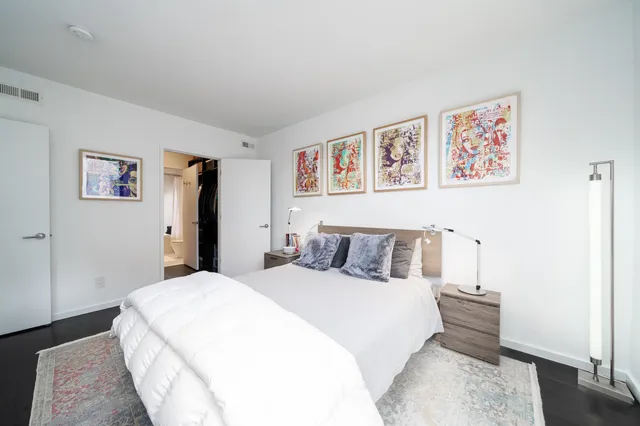 a bed room with a bed and a wall painting